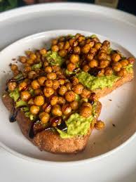 Try this protein-packed avocado and chickpea toast with a zesty lemon-herb dressing. A quick, vegan, gluten-free breakfast or snack full of fresh flavors.
