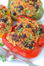 These quinoa and black bean stuffed peppers are packed with flavor and topped with creamy avocado lime sauce. A healthy, vegan, and gluten-free meal perfect for lunch or dinner.